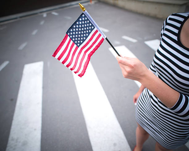 istock woman hand holding american flag 478158646