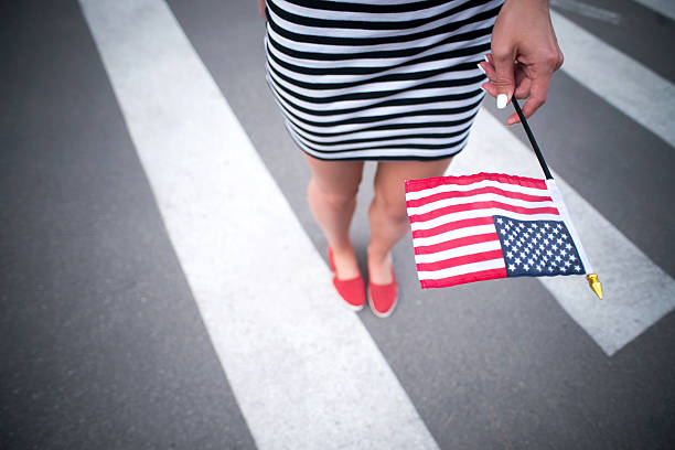 istock woman hand holding american flag 478158650