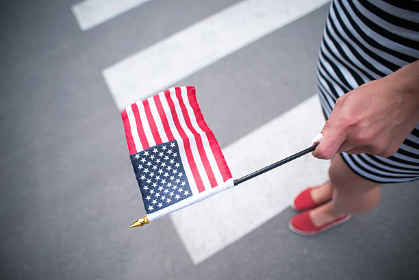 istock woman hand holding american flag 478158652