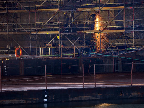 soldador en el trabajo en el patio - industrial ship flash fotografías e imágenes de stock