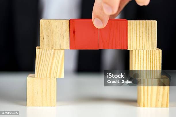 Making A Bridge With Wooden Toy Cubes Stock Photo - Download Image Now - Achievement, Balance, Business