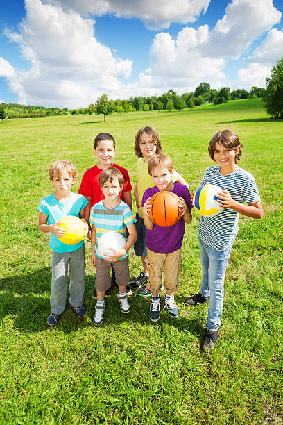 istock Group of six boys holding balls 478158979