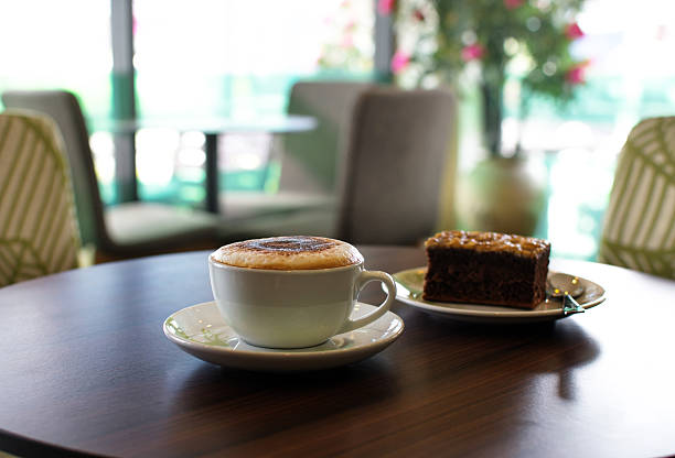 istock Cup of coffee and a cake on the table in 478163468