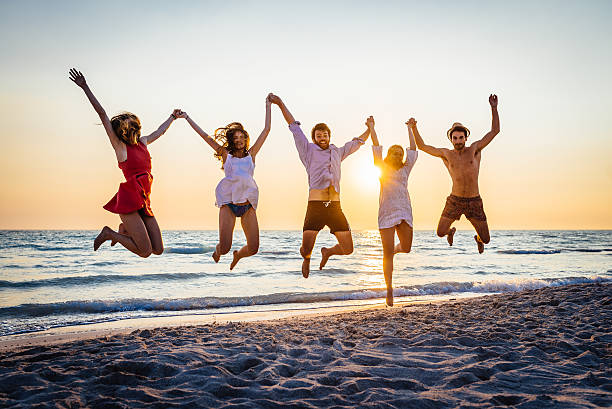 istock Five happy friends jumping on the beach for summer 478163506
