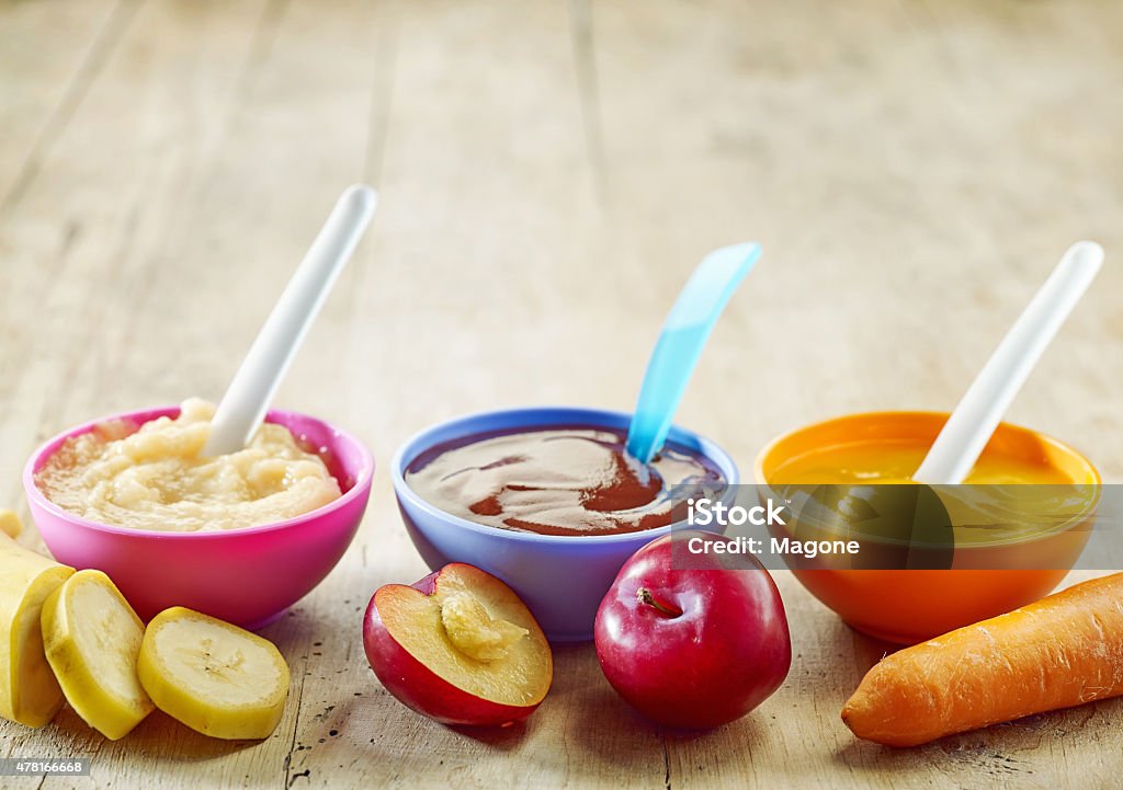 baby food various kinds of baby food in plastic bowls 2015 Stock Photo