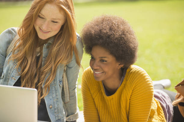 istock Women using laptop in park 478167927