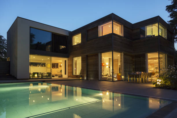 istock Modern house and swimming pool illuminated at dusk 478168139