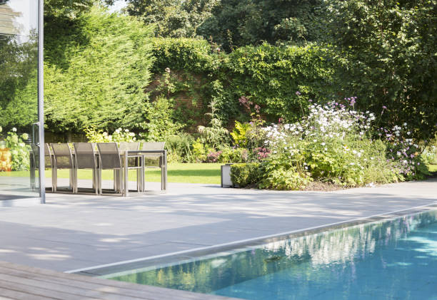 istock Table and chairs by outdoor swimming pool 478168165