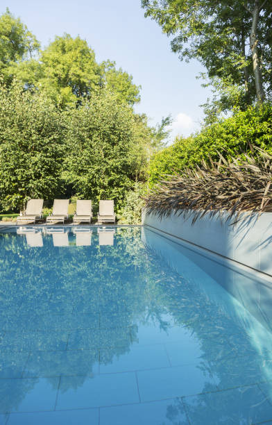 istock Lounge chairs by swimming pool 478168233