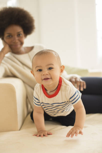 istock Mother and baby boy relaxing on sofa 478168613