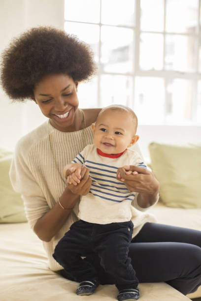 istock Mother and baby boy playing on sofa 478168625