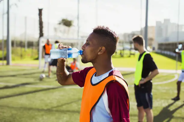 Photo of Soccer player drinking water on field