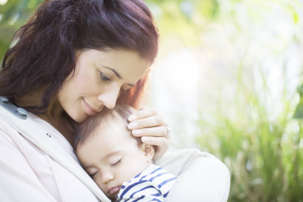 istock Mother holding sleeping baby girl 478169281