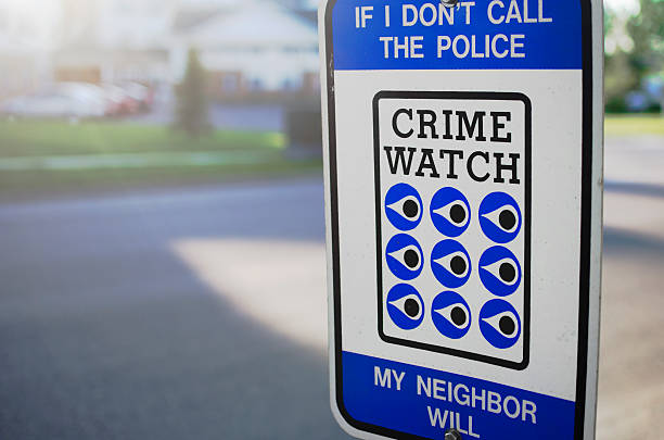 Crime Watch Sign By Street In United States Common and generic crime watch sign in the United States. The crime watch is usually set up by neighbors who watch out for each other's properties, hence the text "If I don't call the police, my neigbor will".  neighborhood crime watch stock pictures, royalty-free photos & images