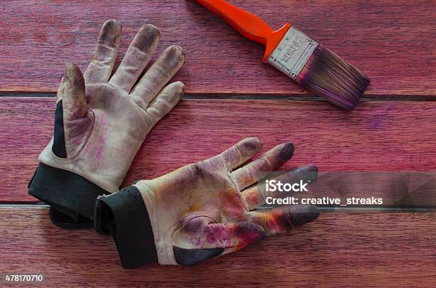 Pair Of Stained Work Gloves And A Paint Brush Stock Photo - Download Image Now - 2015, Black Color, Bristle - Brush Part