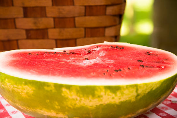 istock Sliced watermelon outdoors on picnic table. Summer. Basket. 478171362