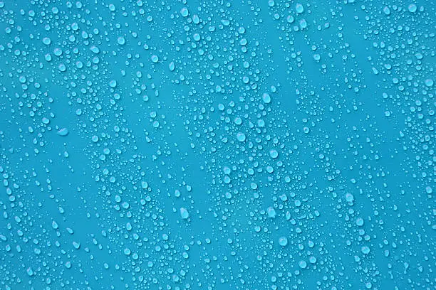 Photo of Water drop texture on blue background.