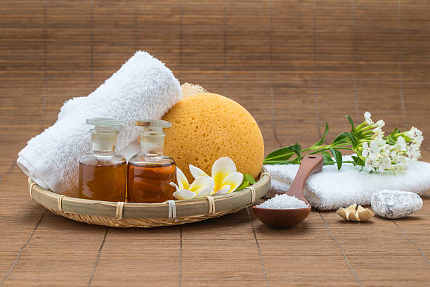istock spa bath, salt spoon, towel sponge essential oil and flower 478180274