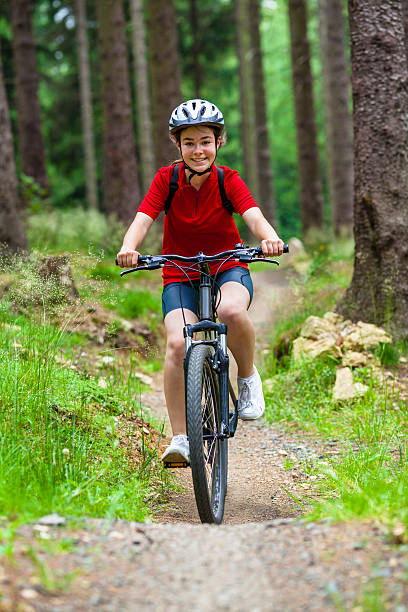 istock Girl riding bike on forest trails 478180456