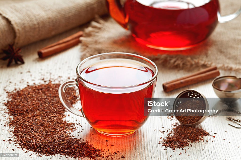 Healthy traditional herbal rooibos beverage tea with spices on vintage Cup of healthy traditional herbal rooibos red beverage tea with spices on vintage wooden table Rooibos Tea Stock Photo