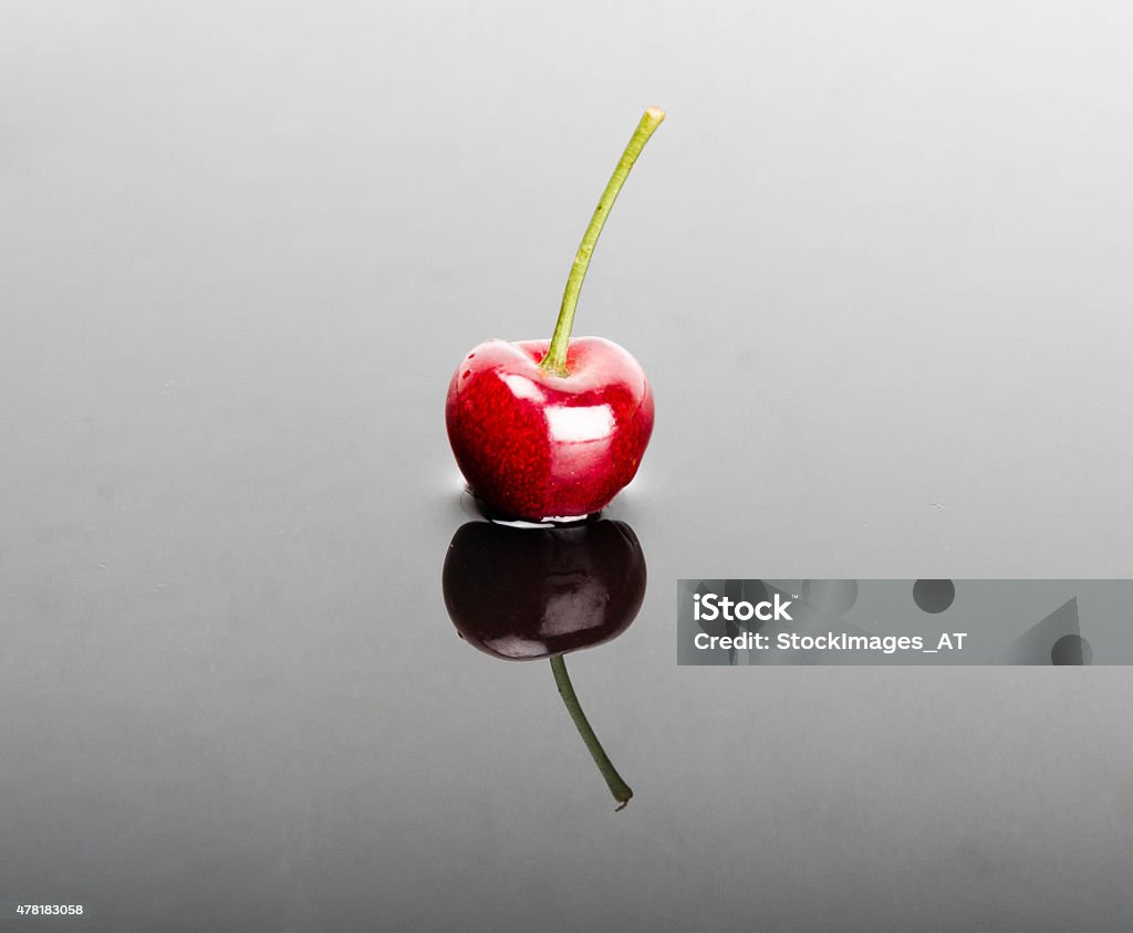Delicious Cherry Delicious cherry with wonderful reflections. Large copy space for your text. Photo made in high quality photo studio with high end equipment.  2015 Stock Photo