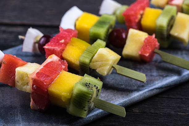 istock Mixed exotic fruits on skewers 478183102