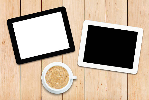 istock Two tablet PCs and coffee on a wooden table 478183352