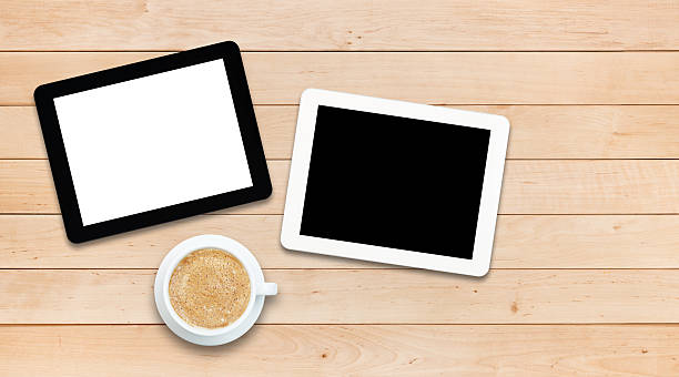 istock Two tablet PCs and coffee on a wooden table 478183442
