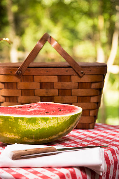 istock Sliced watermelon outdoors on picnic table. Summer. Basket. 478183510