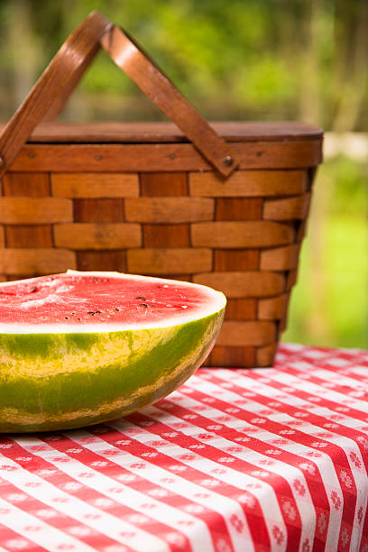 istock Sliced watermelon outdoors on picnic table. Summer. Basket. 478184358