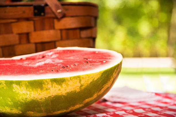 istock Sliced watermelon outdoors on picnic table. Summer. Basket. 478187420