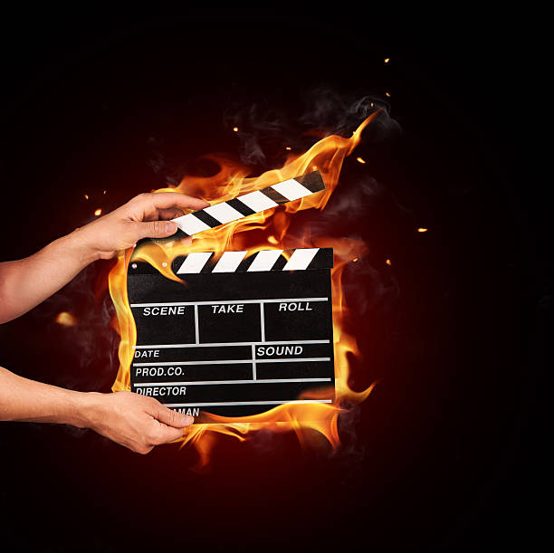 istock Man with film clapper in fire 478188098