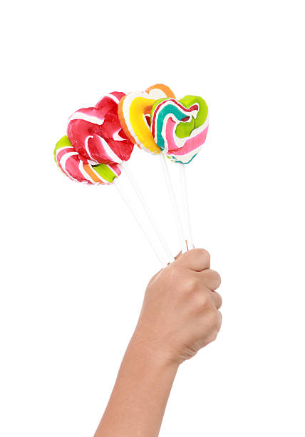 istock Colorful lollipop on children hand  isolated 478190649