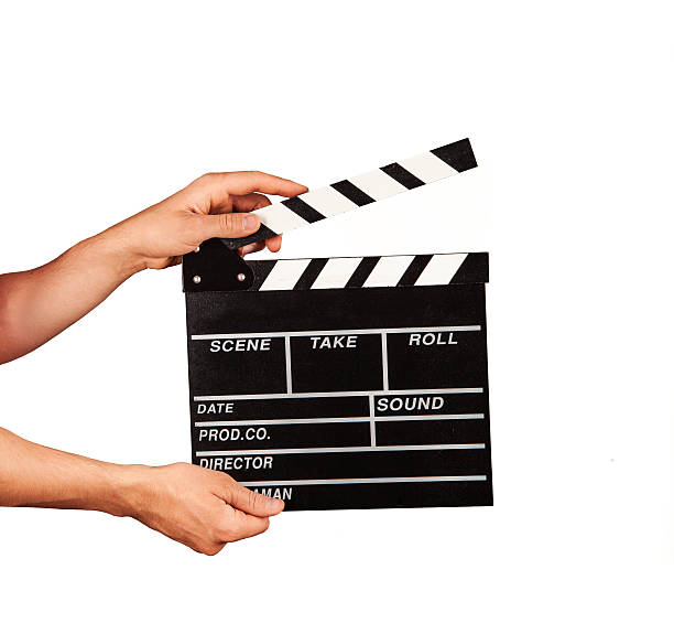 istock Man with film clapper on white background 478190920