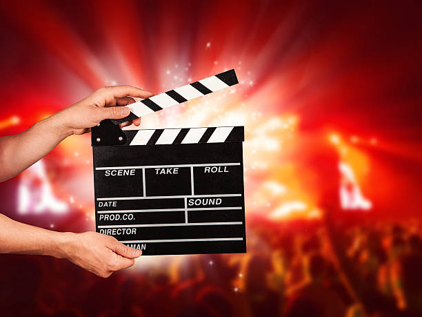 istock Man with film clapper on concert 478190924