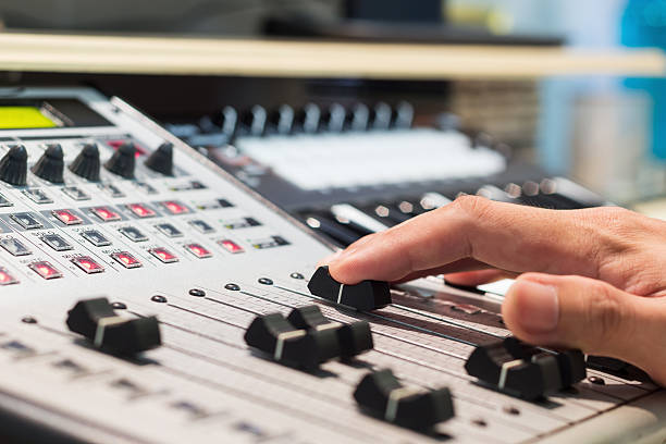 istock sound engineer, DJ right hand on digital studio mixer fader 478192428