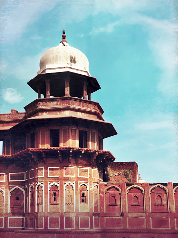 Red Fort in Agra, India. Retro vintage  style, Architectural Detail of Red Fort in Agra, India. The unique red-stoned Agra Fort is situated on the Jumna River a short distance away from the Taj Mahal. The walled city was built in 1573. Fort complex was designated a UNESCO World Heritage Site in 2007.