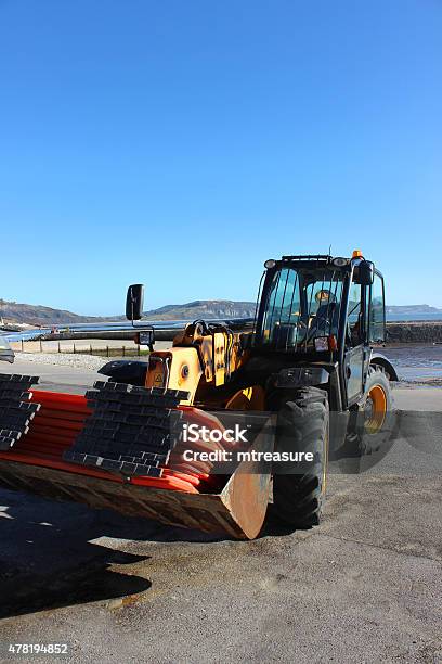 Image Of Tractor Next To Beach Promenade And Harbour Walls Stock Photo - Download Image Now