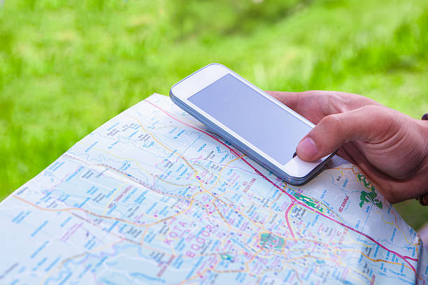 istock Man hand looking direction with maps and mobile phone 478197078