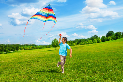 running boy flying a kite 