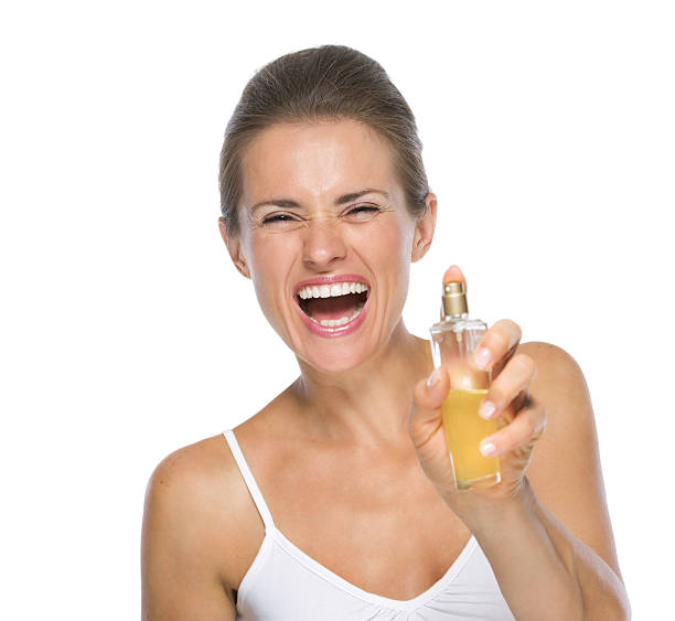 istock happy young woman applying perfume in camera 478199857