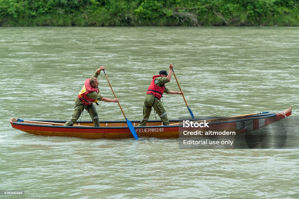 rescue barge in the river Ueberackern, Austria - June 19, 2015: Two fire workers on a rescue barge in the Salzach River. From 19 to June 20, 2015 900 Zille crews of firefighters from Upper Austria and of the other provinces,  also from neighboring Bavaria fighting at the 54th Upper Austrian - barge competition (german: 54. Oberoesterreichischer Landes-Wasserwehrleistungsbewerb) in Ueberackern.  2015 Stock Photo