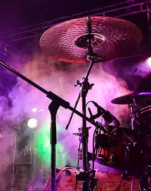 Drum Kit Cymbal captured during Live Music Gig showing stage atmosphere with lighting and smoke effects