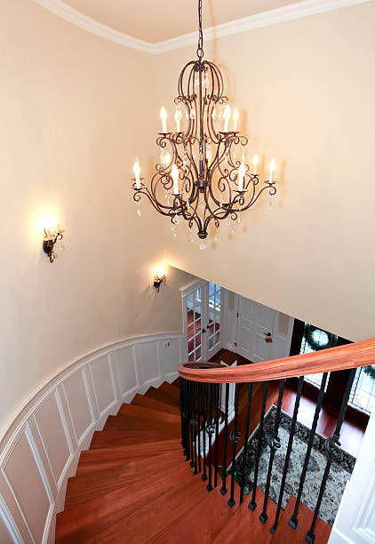 istock Luxury curved staircase with chandelier and harwood. 478200595