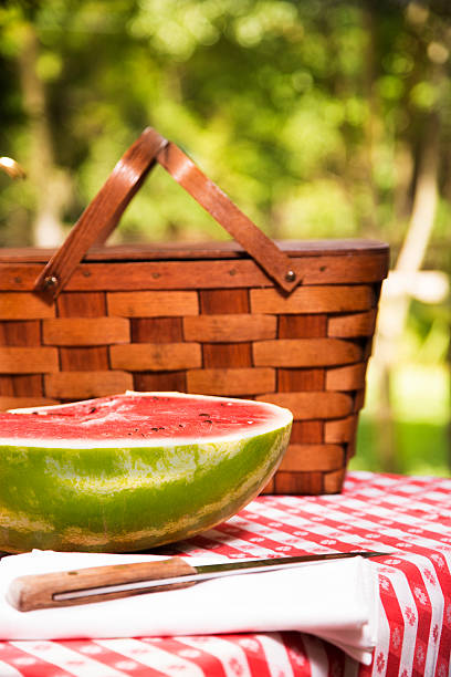 istock Sliced watermelon outdoors on picnic table. Summer. Basket. 478200830
