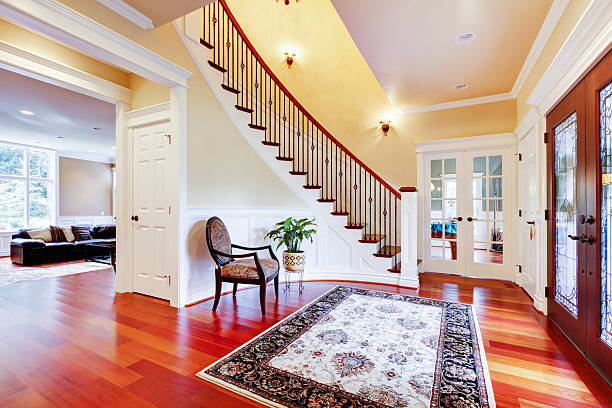 Luxury home entrance with cherry hardwood floor and staircase. stock photo