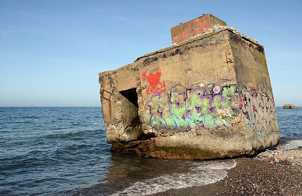 Wustrow, Germany - March 8, 2014: Bomb shelter with graffiti on shore of baltic sea. walk on beach from Wustrow towards Ahrenshoop