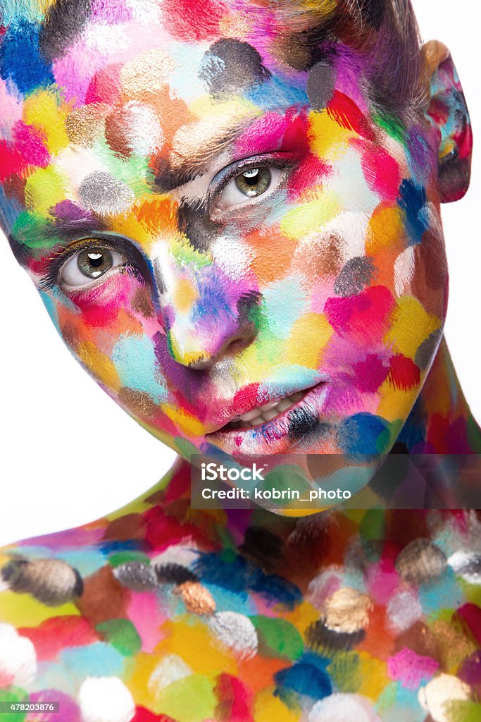 Girl with colored face painted. Art beauty image Girl with colored face painted. Art beauty image. Picture taken in the studio on a white background. Paint Stock Photo