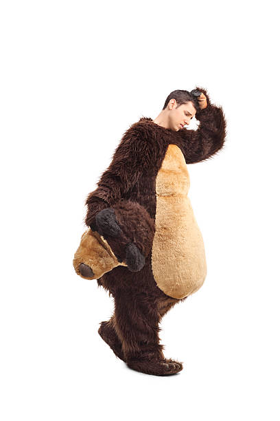 istock Sad young man in a bear costume walking 478203884