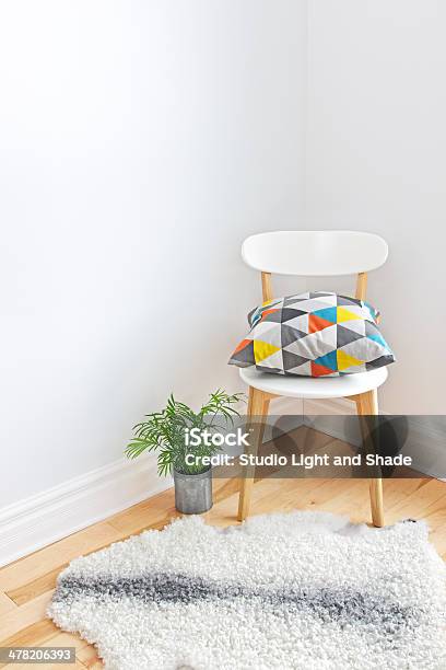 Chair With Bright Cushion And Sheepskin Rug On The Floor Stock Photo - Download Image Now